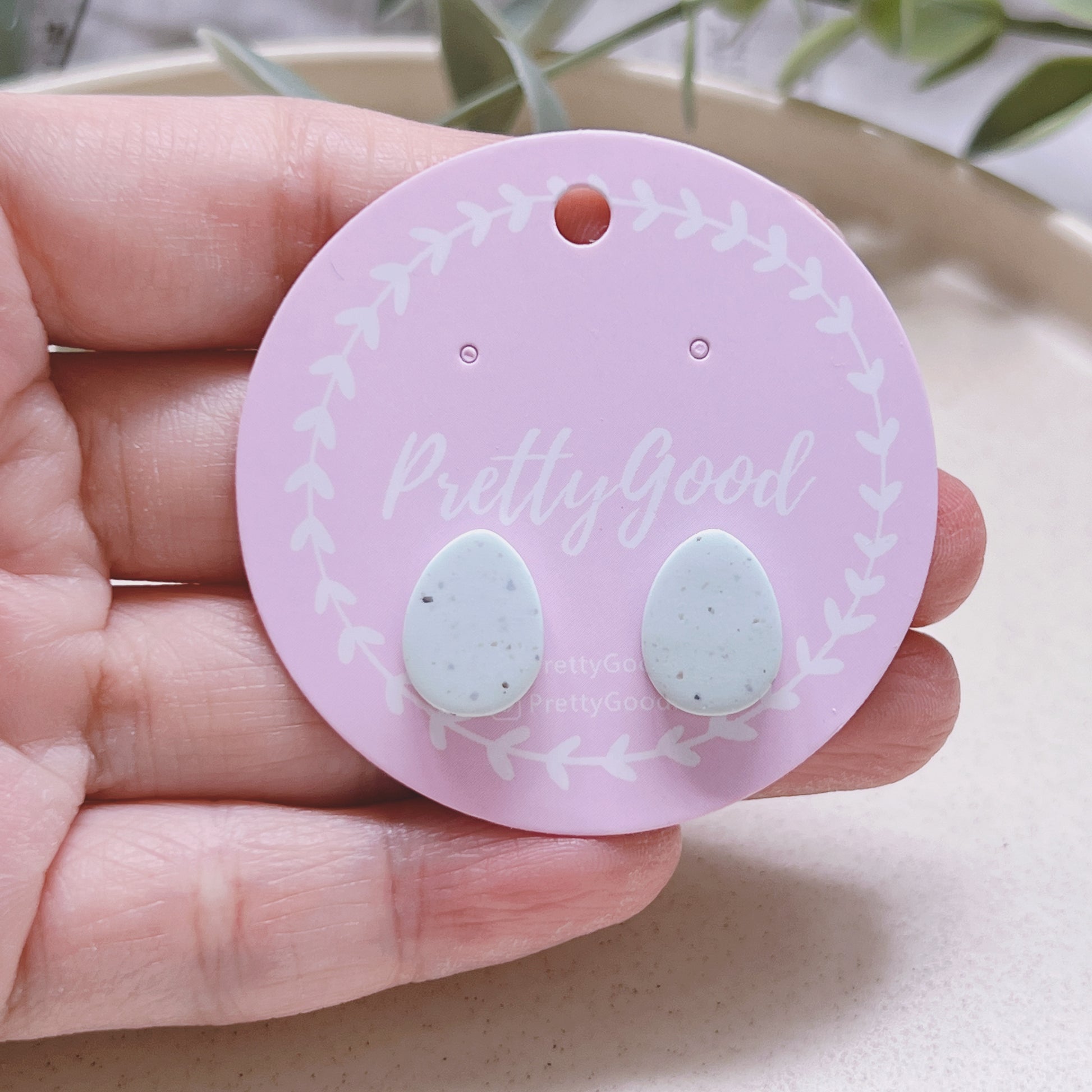 Handmade Pastel Mint Eggs Studs Earrings against hand - by PrettyGood Singapore